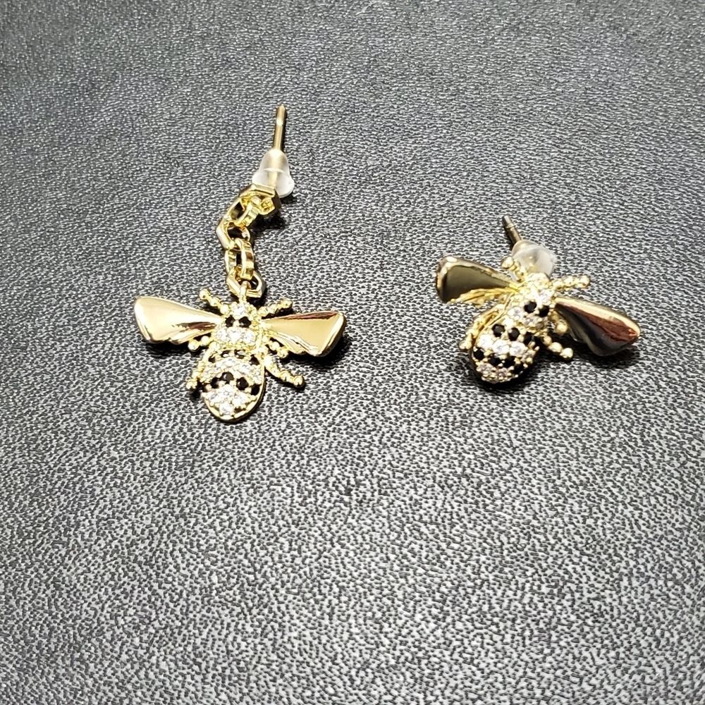 Gold tone asymmetrical bee earrings black clear